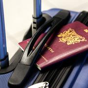 Ein Reisepass liegt auf einem Koffer